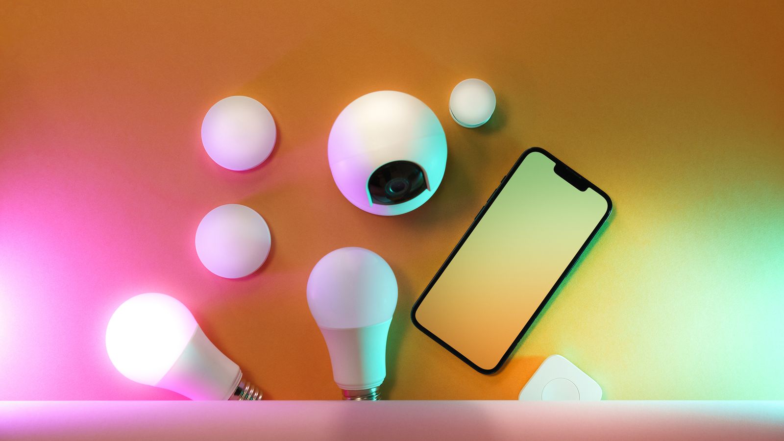 A collection of smart home devices including light bulbs and a smartphone, showcasing modern technology.