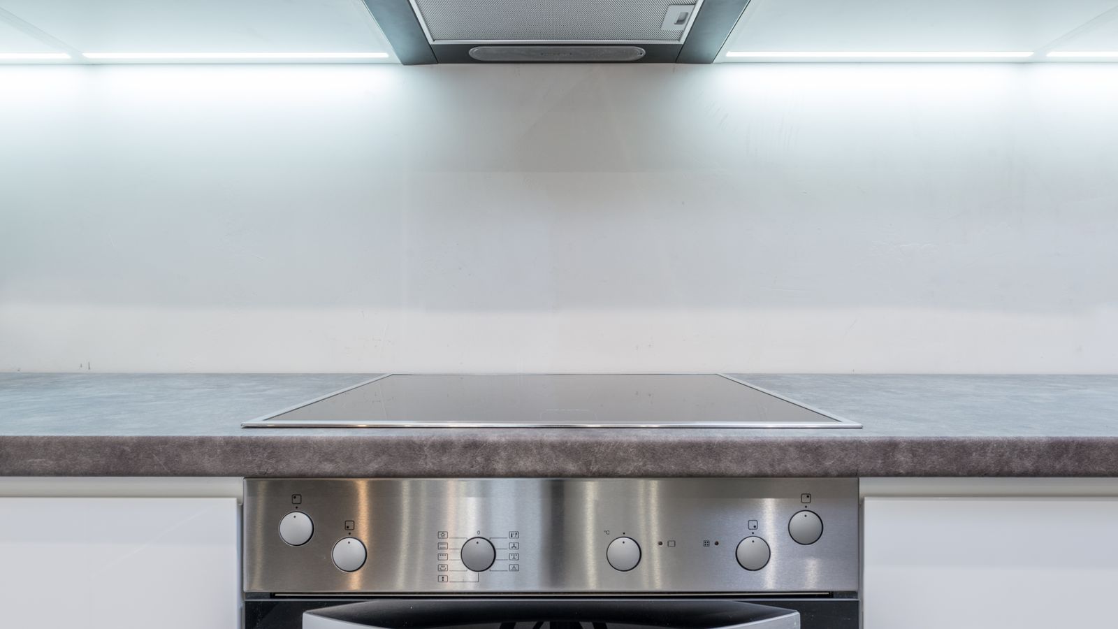 A sleek, modern kitchen with steel appliances and minimalist design.
