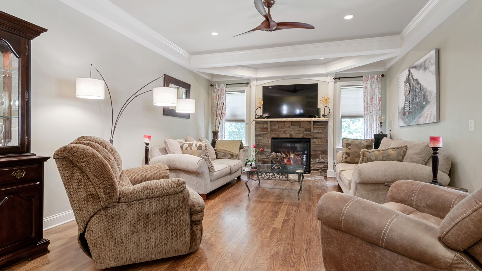 Spacious and elegant living room featuring contemporary furniture and a fireplace.