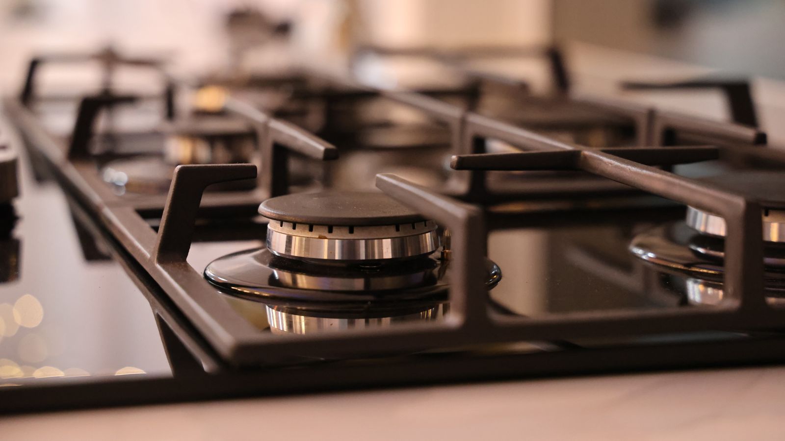 Close-up of a modern stainless steel gas stove top, ideal for contemporary kitchens and cooking environments.
