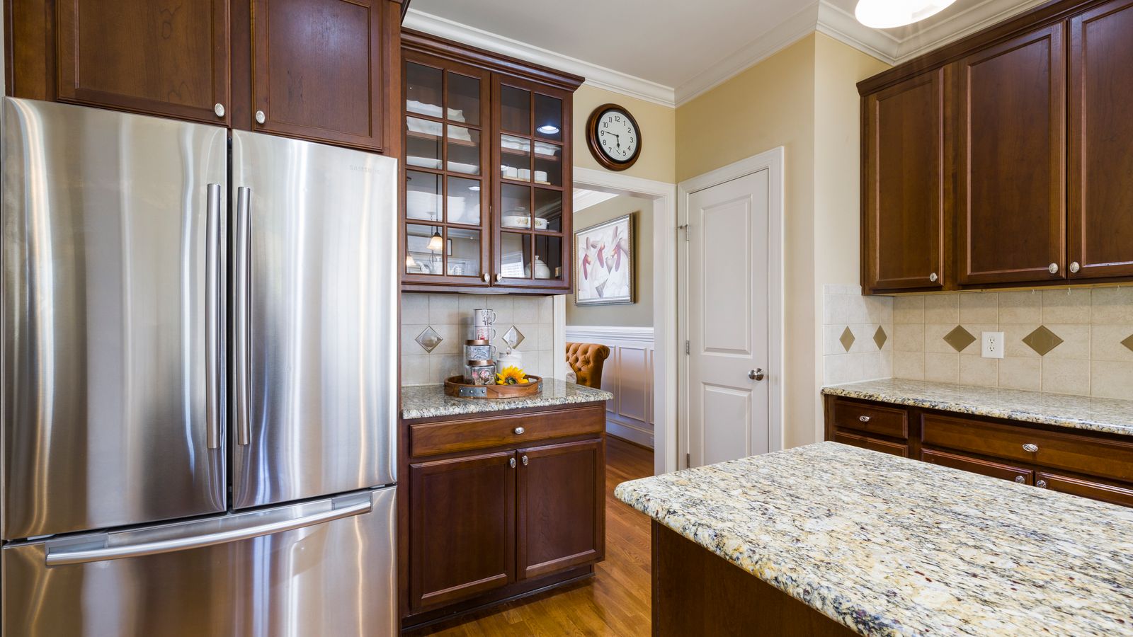 Spacious kitchen featuring stainless steel appliances and elegant wood cabinetry with granite countertops.