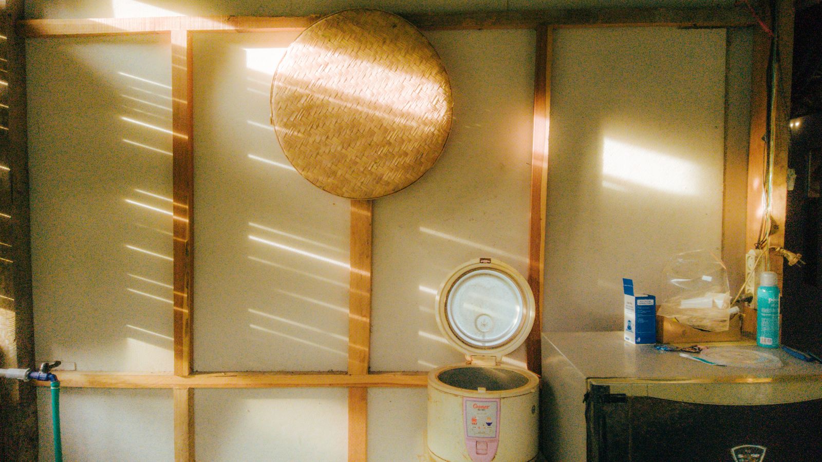 Vintage style kitchen with a rice cooker and sunlight streaming through, creating a nostalgic ambiance.